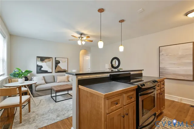 a kitchen with stove cabinets and dining table