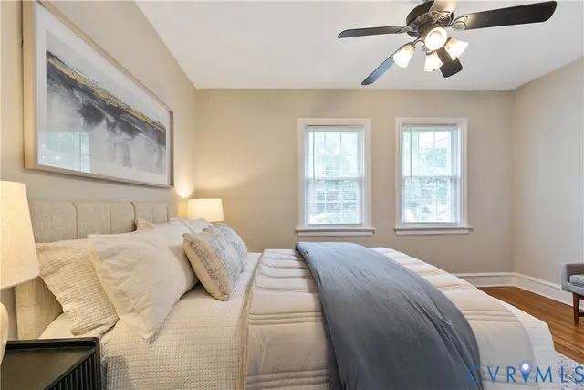 a bedroom with a bed and a painting on the wall