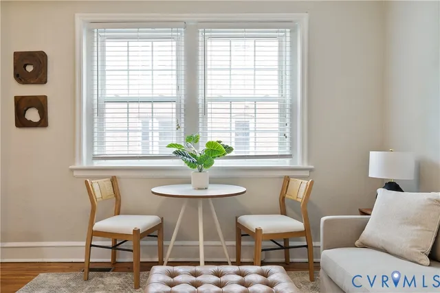 a view of a dining room with furniture and a window