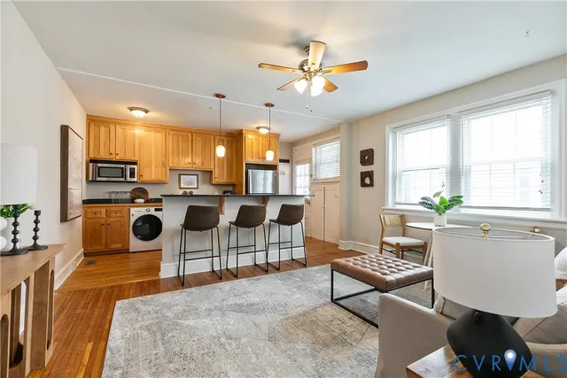 a living room with furniture a rug and a window