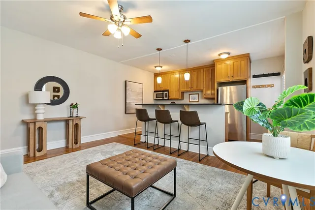 a view of a dining room with furniture and a potted plant