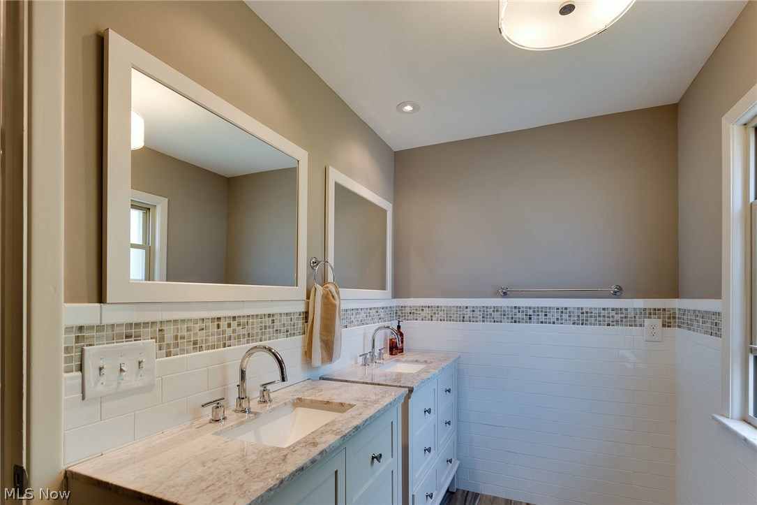 1046 Allston Road Cleveland Heights, OH 44121 - Photo 33 of 34 Plenty of space with two individual vanities and mirrors. Subway tile walls with inlaid glass mosaic tile accents. All new from floor to ceiling!
