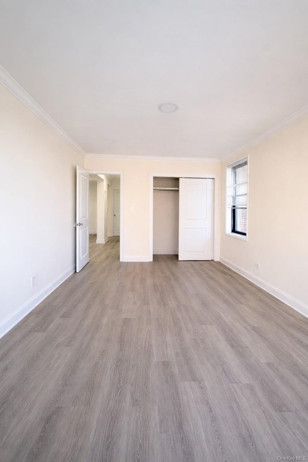 150-11 72nd Road, Unit 4 Queens, NY 11367 - Photo 8 of 12 a view of empty room with wooden floor and fan