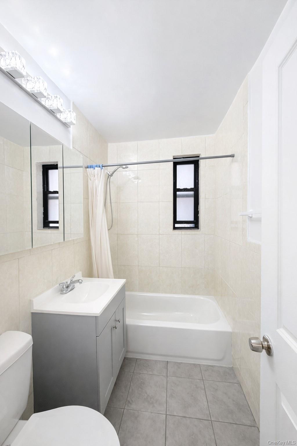 150-11 72nd Road, Unit 4 Queens, NY 11367 - Photo 10 of 12 a bathroom with a sink a toilet and shower