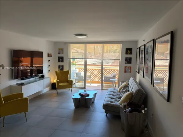 a living room with furniture and a flat screen tv with wooden floor