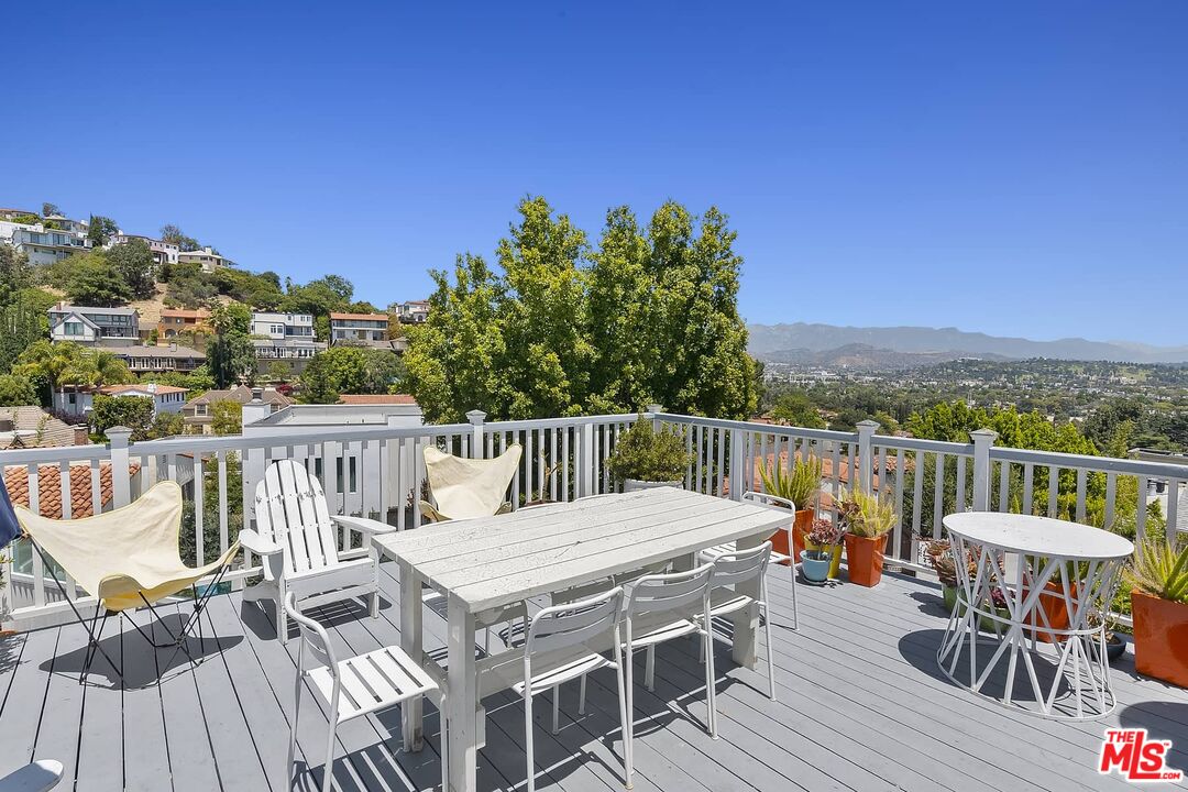 3347 Ley Drive Los Angeles, CA 90027 - Photo 13 of 25 a view of a roof deck with table and chairs with wooden floor and fence