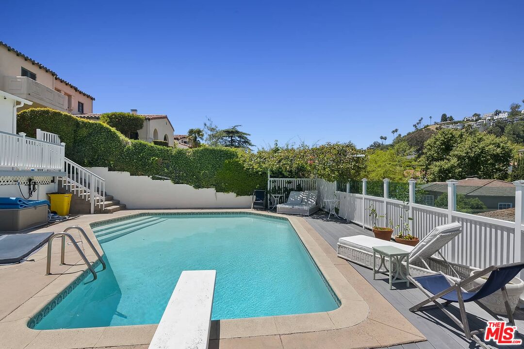 3347 Ley Drive Los Angeles, CA 90027 - Photo 14 of 25 a view of a swimming pool with a lounge chairs