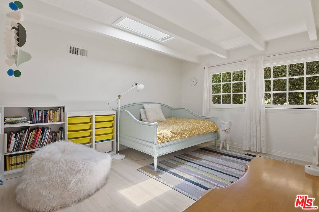 3347 Ley Drive Los Angeles, CA 90027 - Photo 21 of 25 a bedroom with a bed and a book shelf