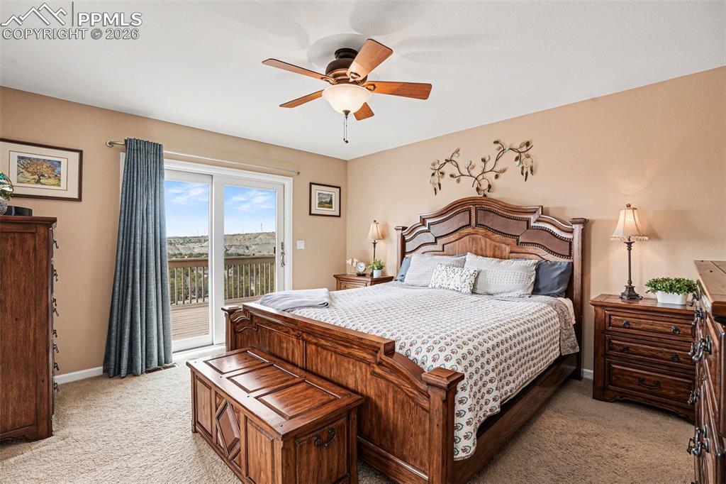 459 Bowie Road Penrose, CO 81240 - Photo 19 of 47 The primary suite features soft carpet flooring with a walk out to a deck and a hot tub & 5-piece bath showcasing stunning views.