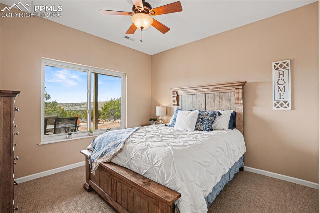 459 Bowie Road Penrose, CO 81240 - Photo 27 of 47 The 1st basement bedroom is spacious and versatile, featuring ample natural light and carpeted flooring. They are ideal for guests, family, or a home office, conveniently located near the basement bathroom and large family room for added comfort and functionality.
