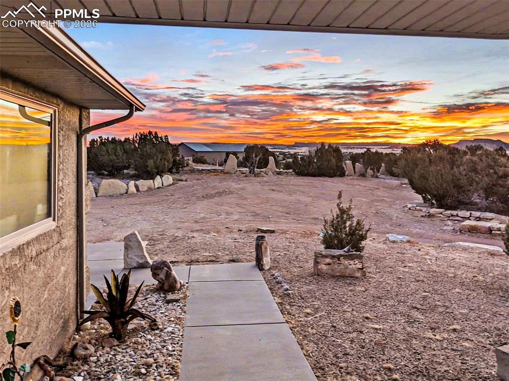 459 Bowie Road Penrose, CO 81240 - Photo 36 of 47 Enjoy breathtaking Colorado sunsets from the Trex deck, hot tub, and back patios or front where expansive views of the mountains and open space create the perfect backdrop for relaxation and outdoor entertaining.