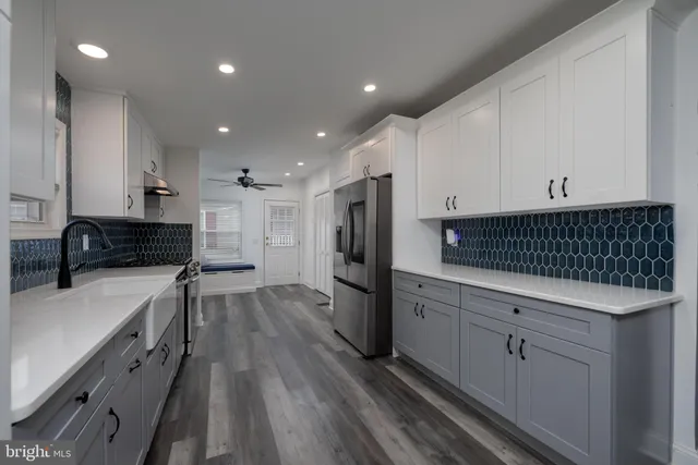 a kitchen with refrigerator and cabinets