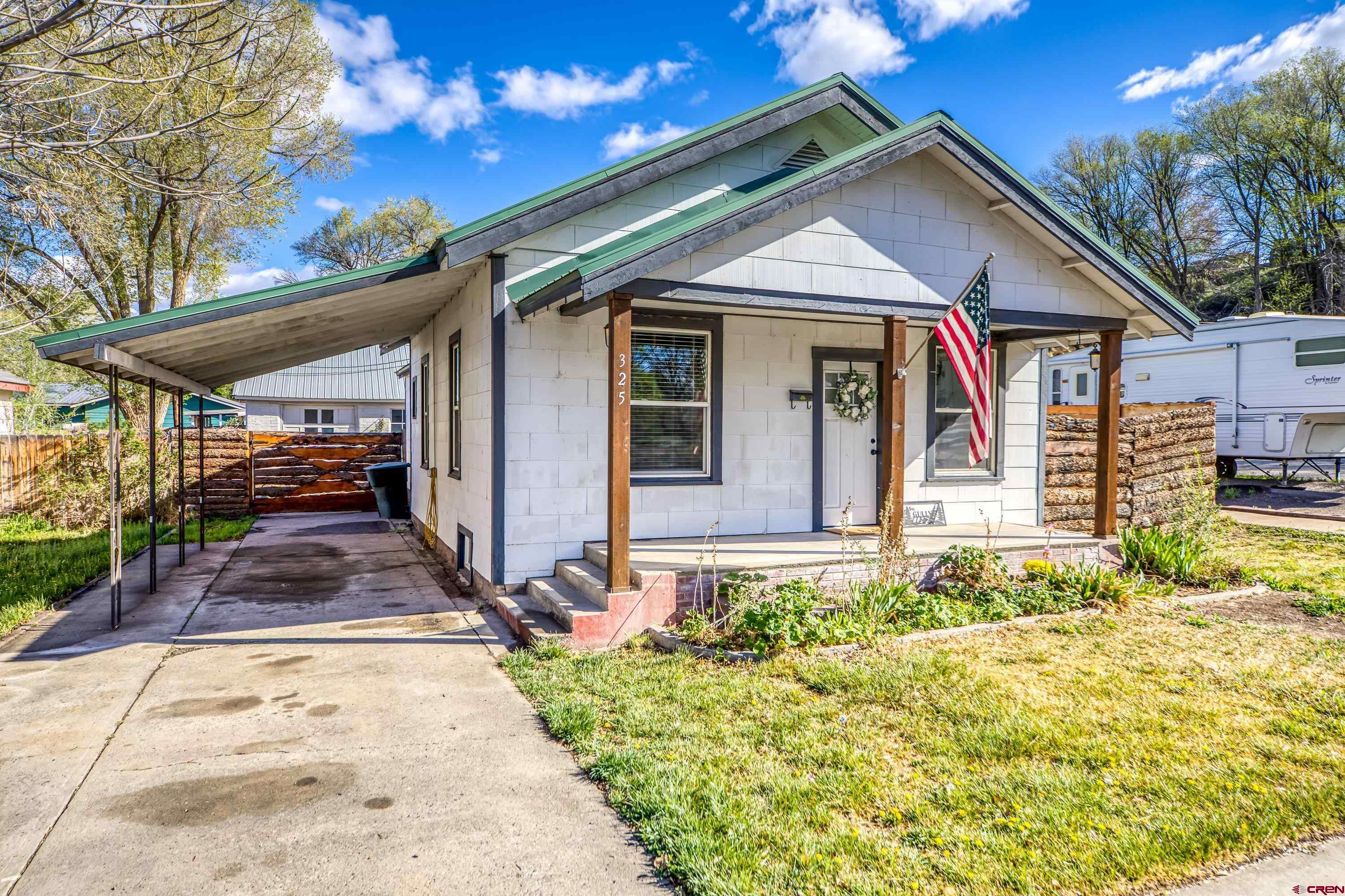 325 East 3rd Street Delta, CO 81416 - Photo 1 of 23 a front view of a house with a yard