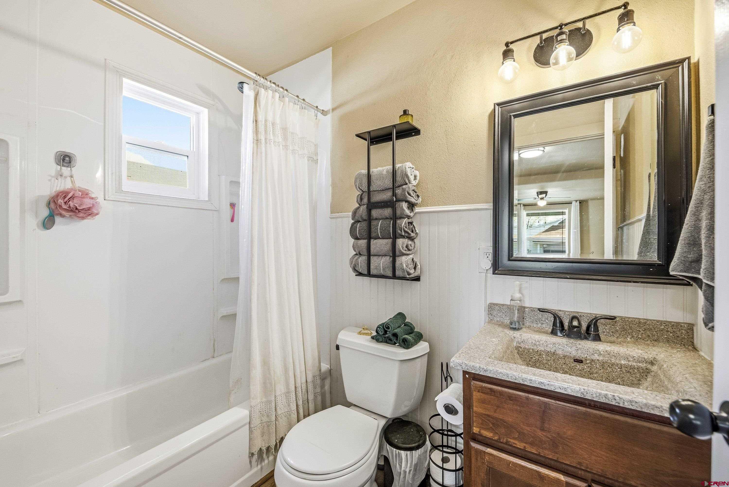 325 East 3rd Street Delta, CO 81416 - Photo 11 of 23 a bathroom with a sink vanity mirror and toilet