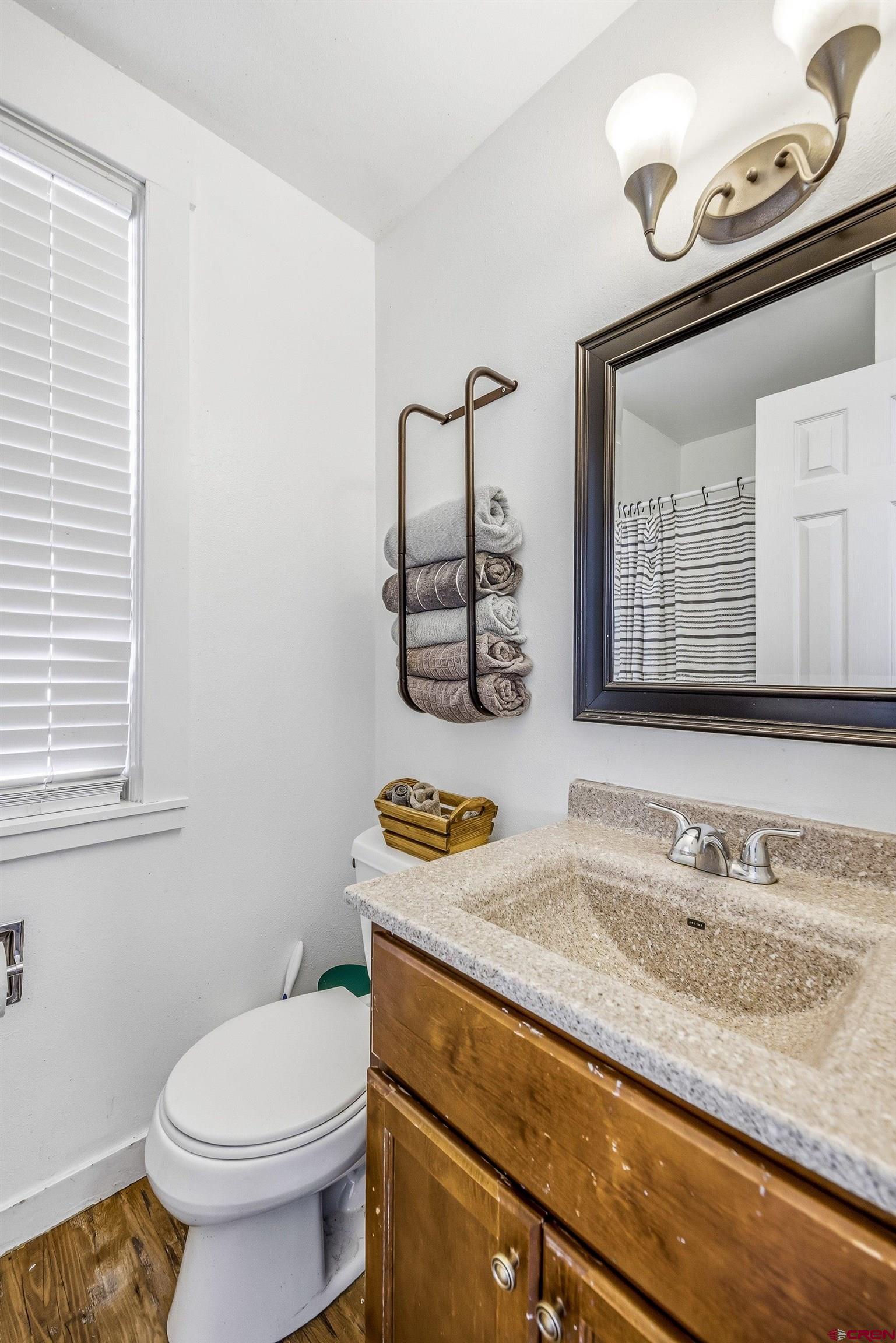 325 East 3rd Street Delta, CO 81416 - Photo 13 of 23 a bathroom with a granite countertop sink and a mirror