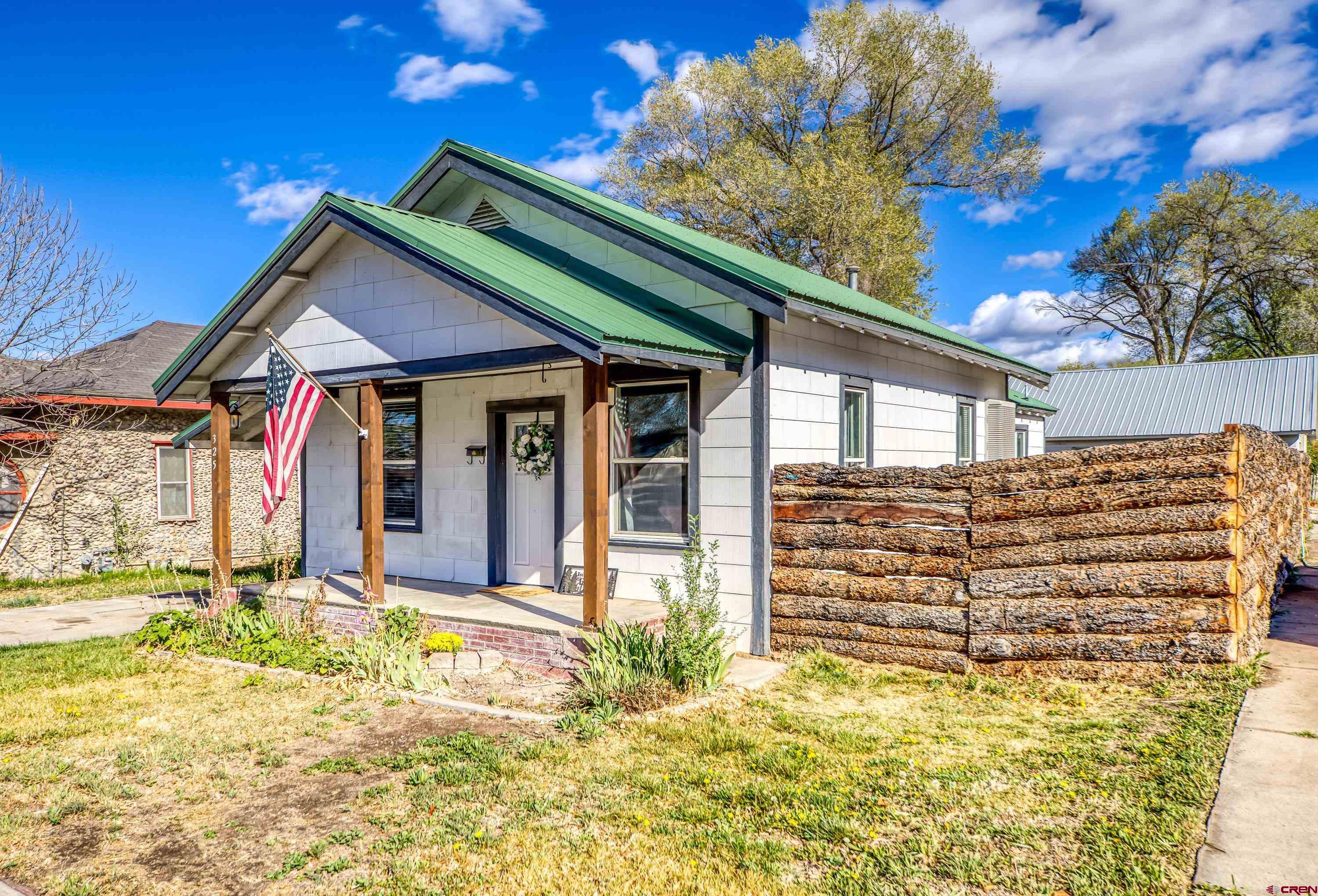 325 East 3rd Street Delta, CO 81416 - Photo 2 of 23 a front view of a house with a garden