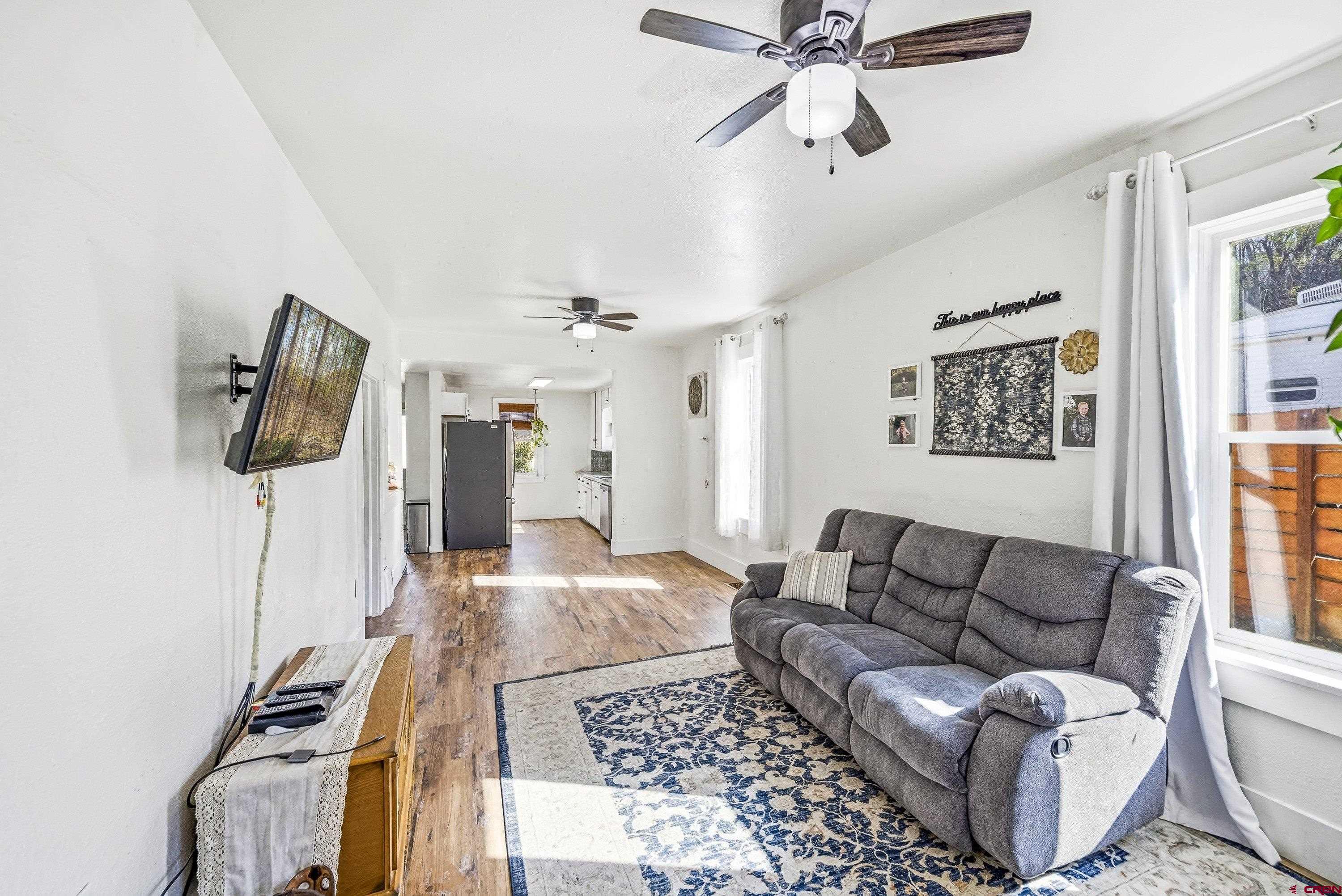 325 East 3rd Street Delta, CO 81416 - Photo 6 of 23 a living room with furniture and a flat screen tv