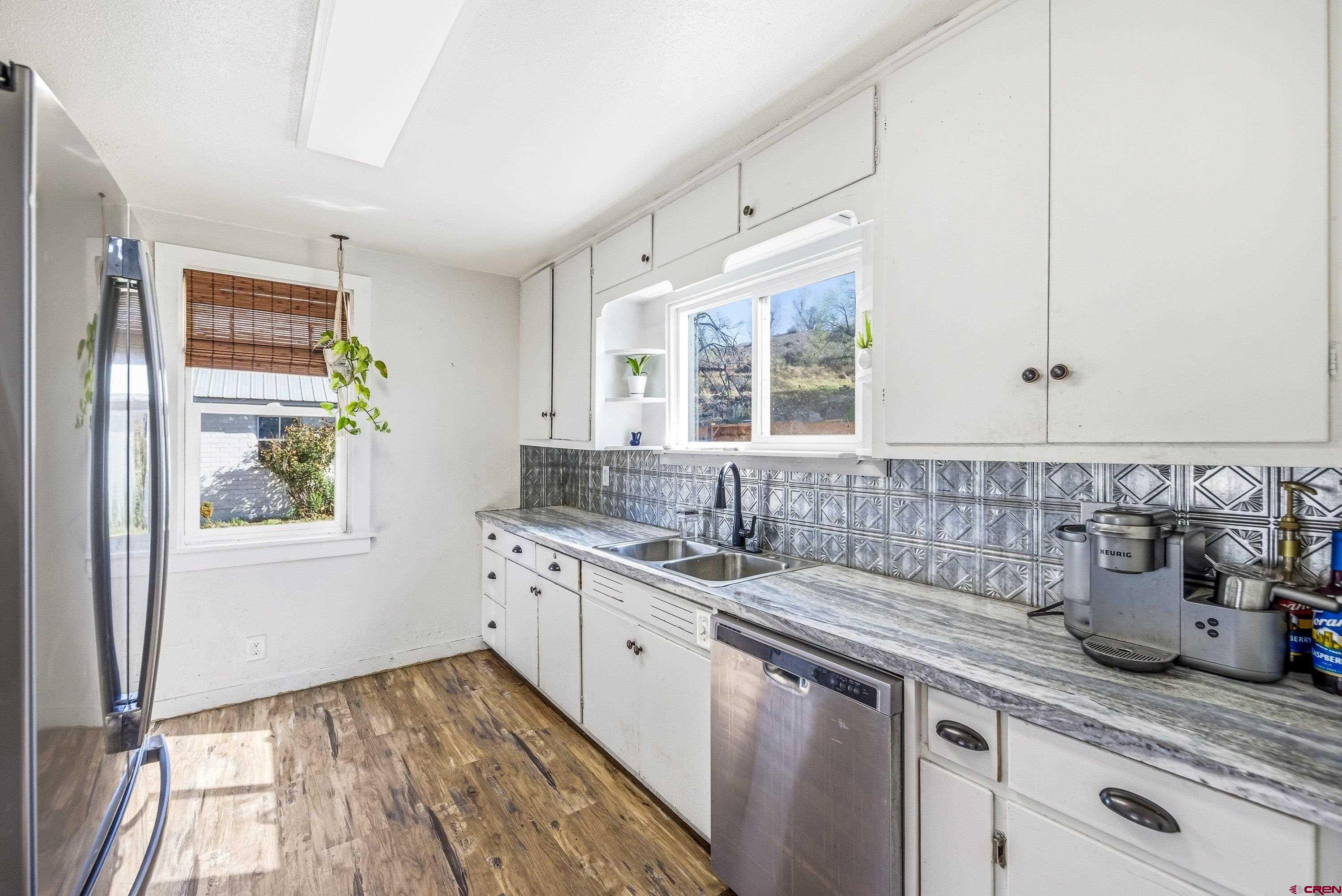 325 East 3rd Street Delta, CO 81416 - Photo 7 of 23 a kitchen with a sink stove and cabinets