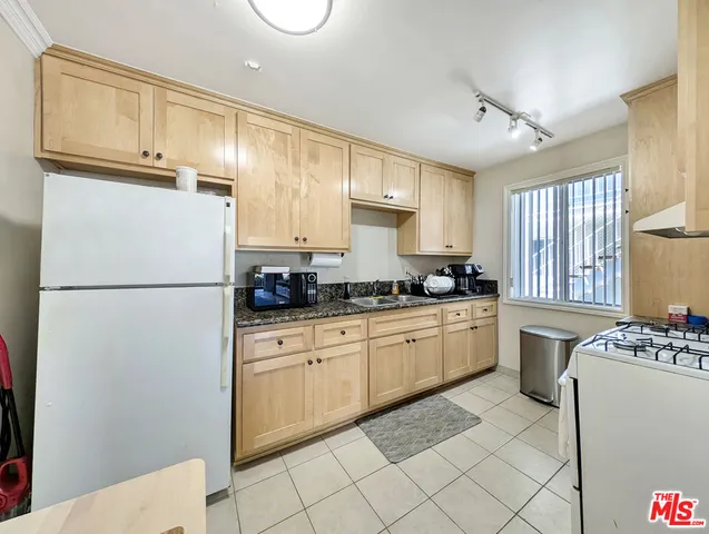 a kitchen with cabinets stainless steel appliances and window