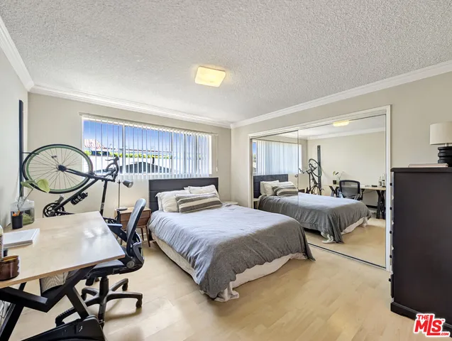 a bedroom with two beds and a dresser