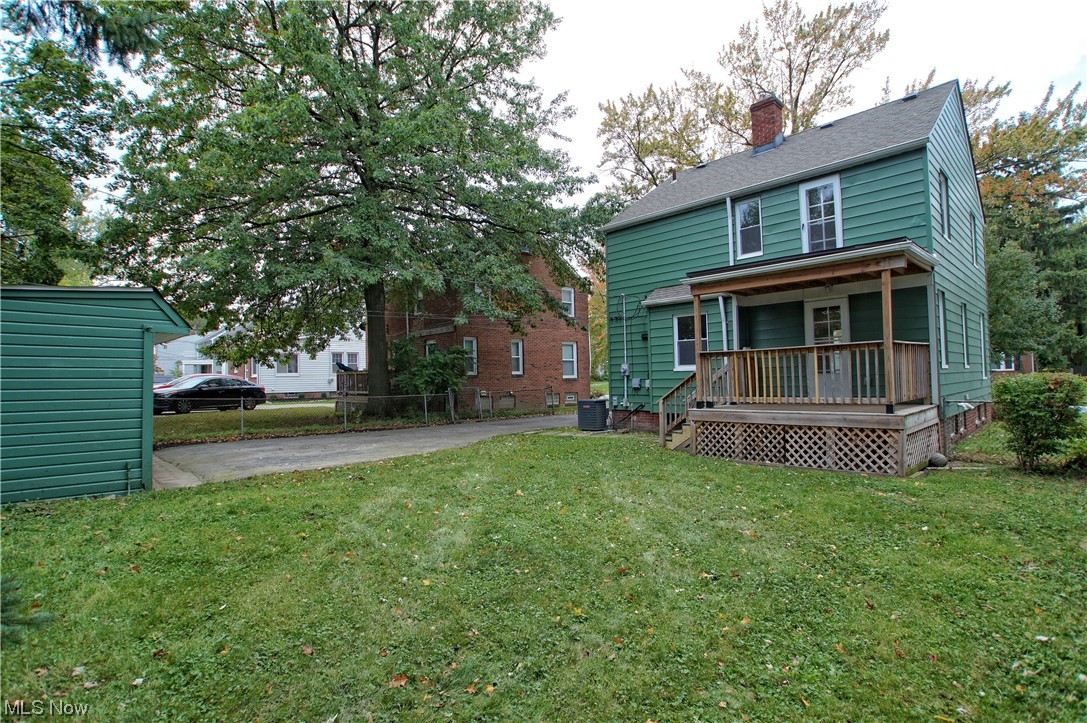 1387 Winston Road Cleveland, OH 44121 - Photo 6 of 29 Back of house featuring a yard and central air condition unit