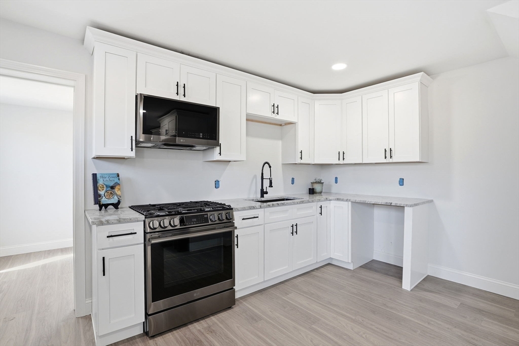 357 Wareham Street Middleboro, MA 02346 - Photo 6 of 42 a kitchen with stainless steel appliances white cabinets and a stove top oven