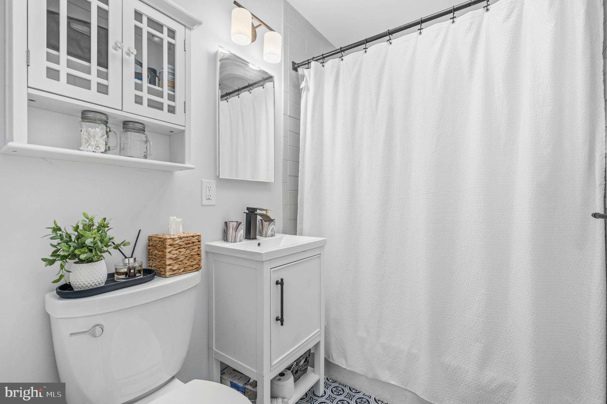 5 Ericsson Road Cabin John, MD 20818 - Photo 28 of 56 a white painted room with a sink and curtain