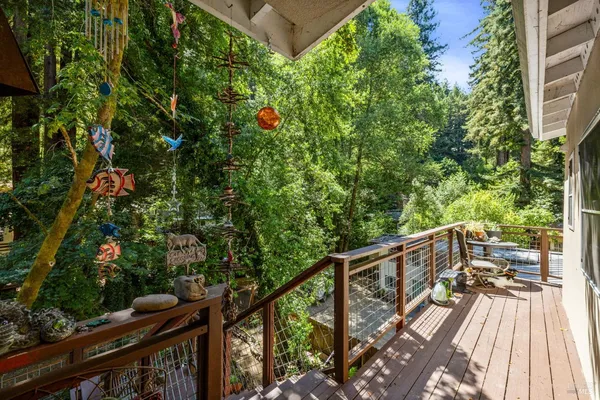 a view of balcony with wooden floor and fence