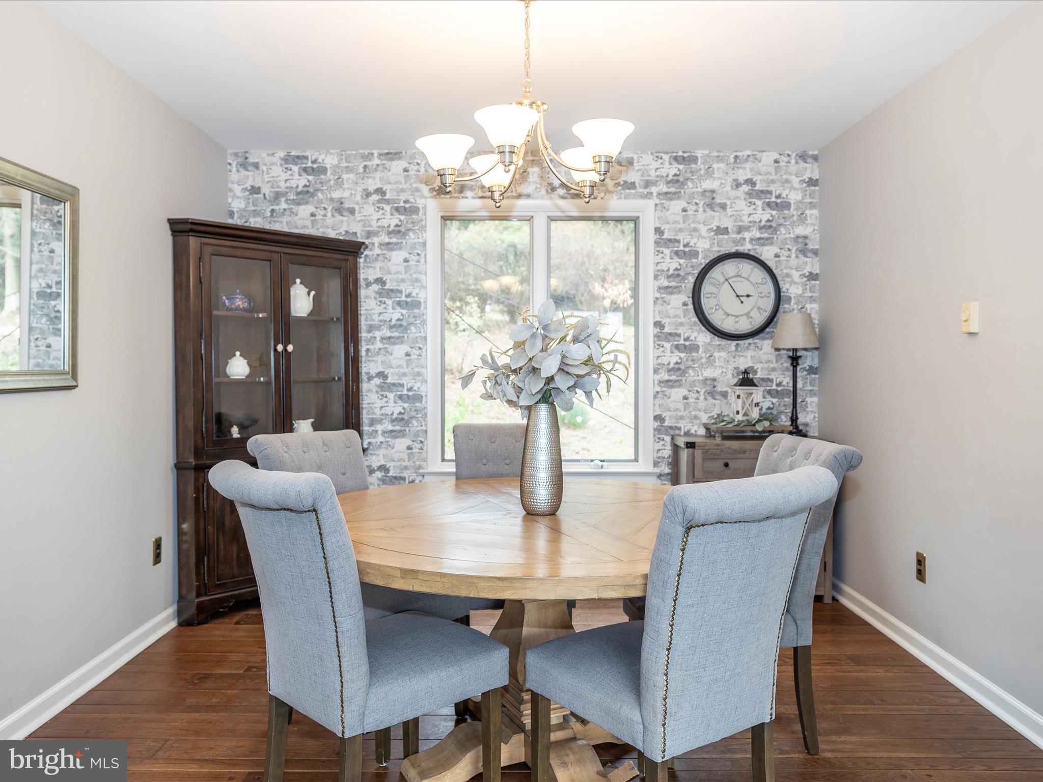 4426 Teen Barnes Road Frederick, MD 21703 - Photo 13 of 76 a view of a dining room with furniture a chandelier and wooden floor