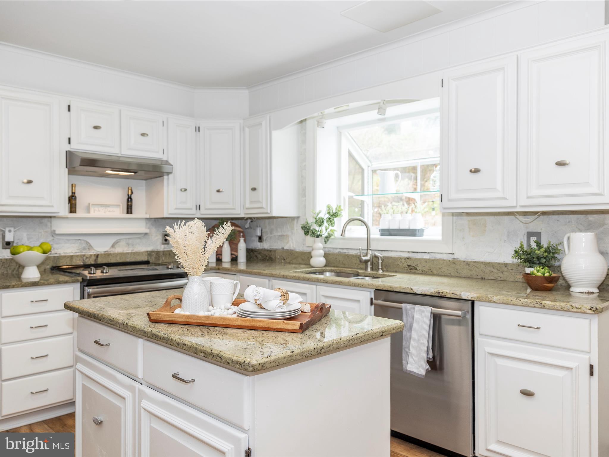 4426 Teen Barnes Road Frederick, MD 21703 - Photo 16 of 76 a kitchen with granite countertop white cabinets white appliances a sink and a window