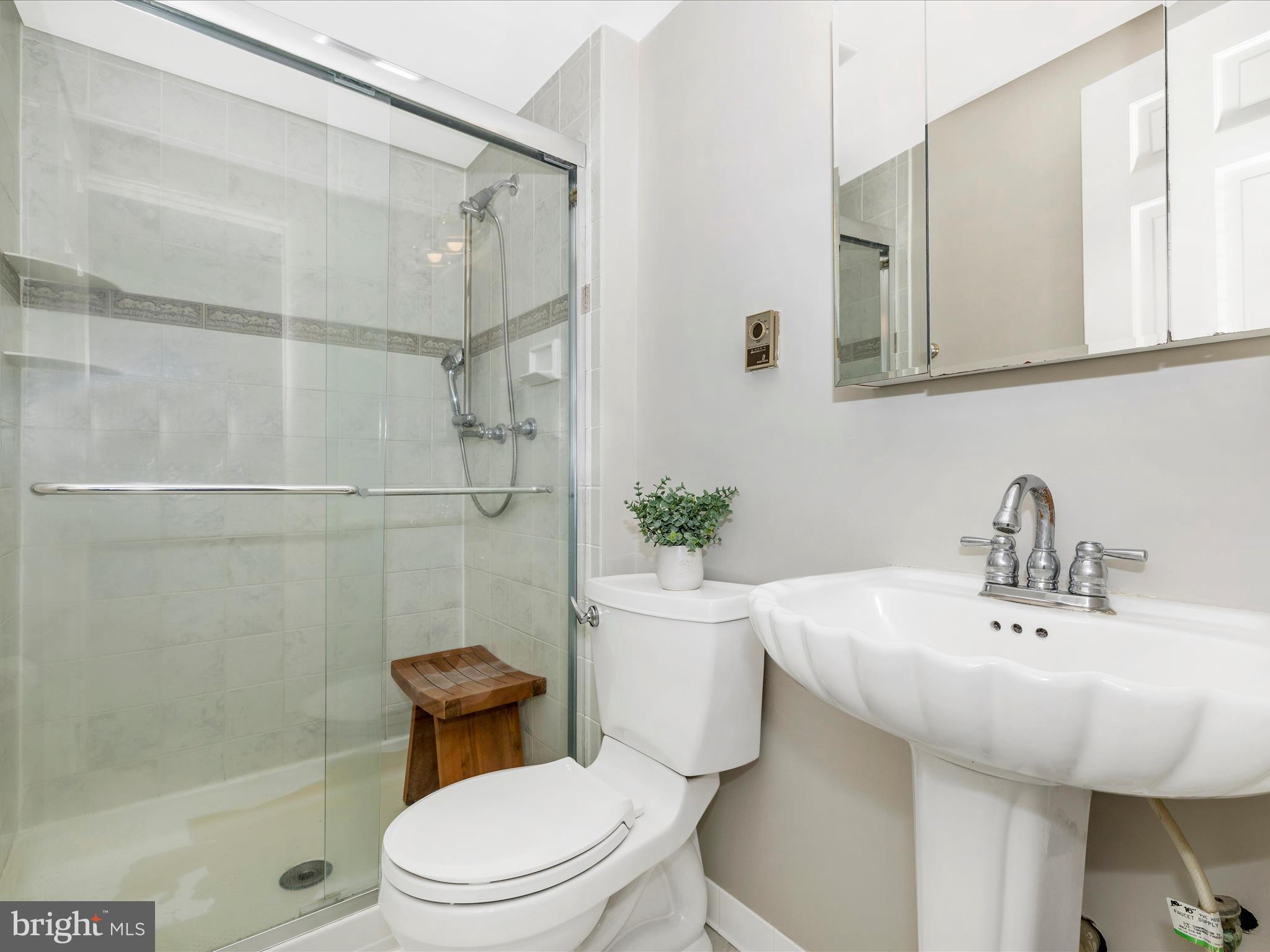 4426 Teen Barnes Road Frederick, MD 21703 - Photo 35 of 76 a bathroom with a sink a toilet and shower
