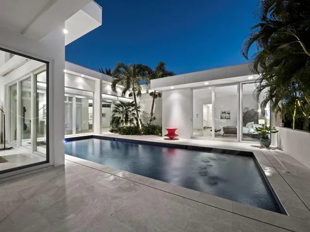 a view of a patio with chairs and potted plants