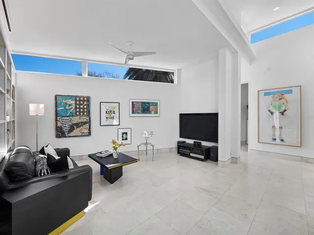 a spacious bedroom with a large bed and a large window