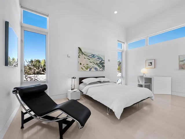 a view of a hallway with wooden floor and a dining table