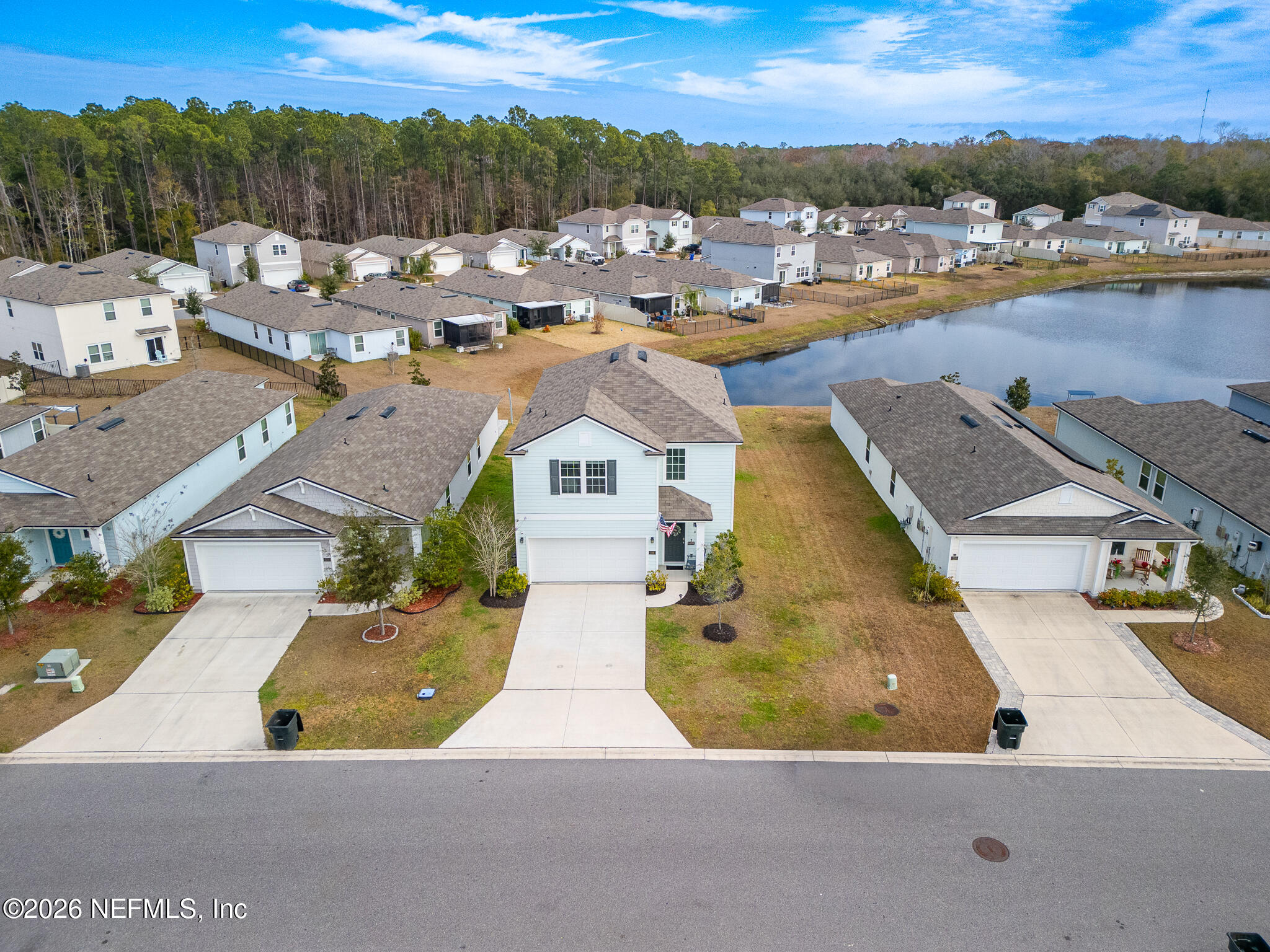 an aerial view of a house with a ocean view