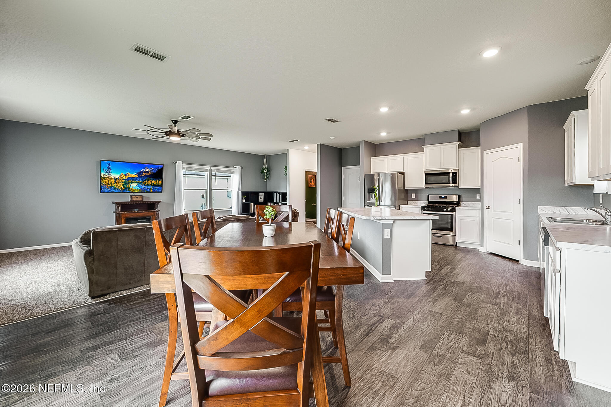 266 Caminha Road St. Augustine, FL 32084 - Photo 18 of 57 a living room with stainless steel appliances furniture dining table and wooden floor
