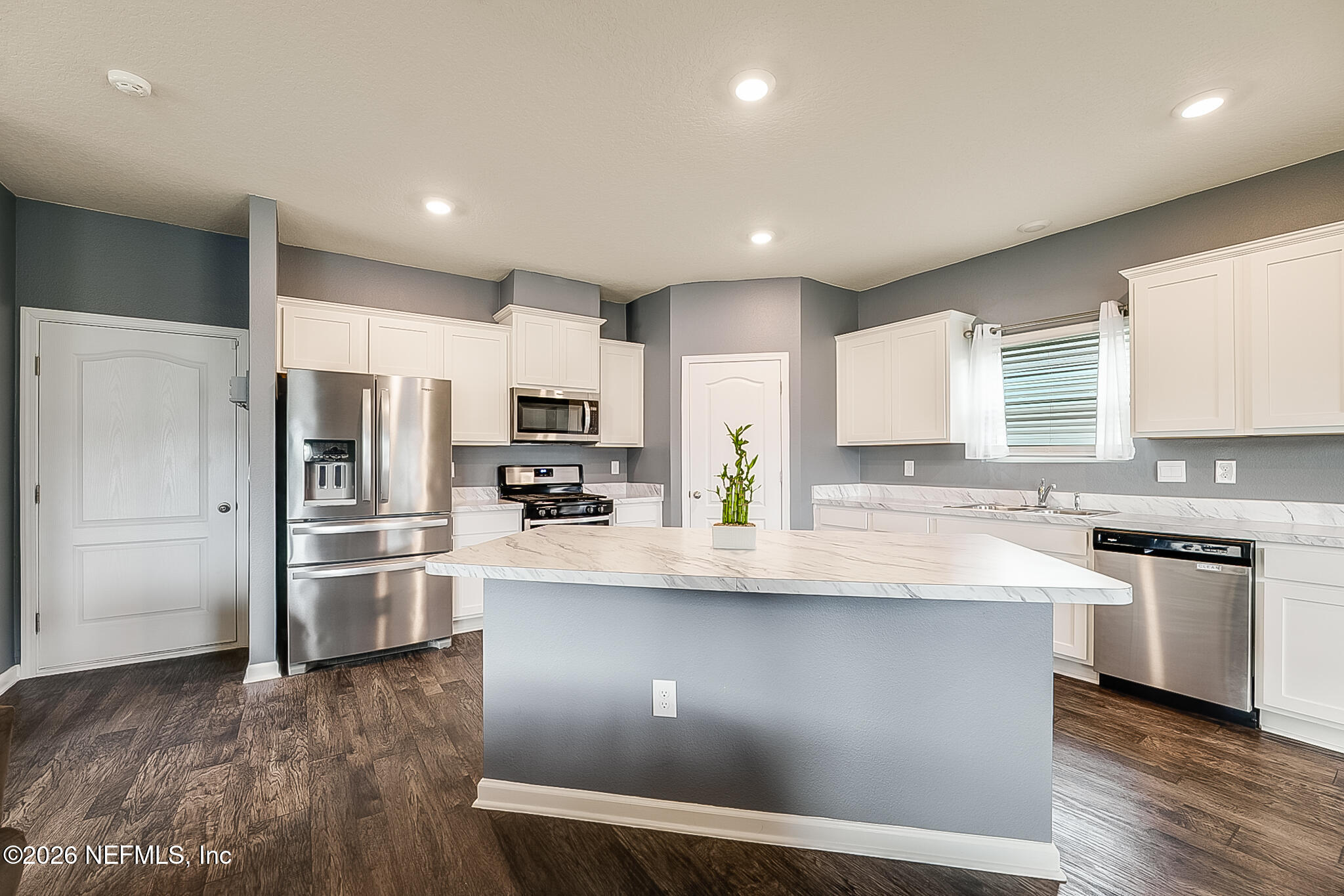 266 Caminha Road St. Augustine, FL 32084 - Photo 19 of 57 a kitchen with stainless steel appliances granite countertop a sink a stove a refrigerator and cabinets