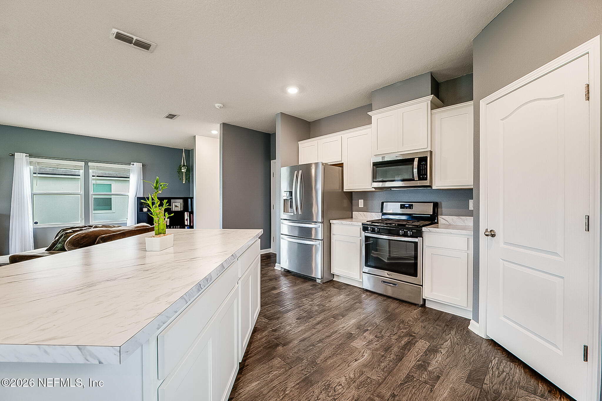 266 Caminha Road St. Augustine, FL 32084 - Photo 20 of 57 a large white kitchen with stainless steel appliances
