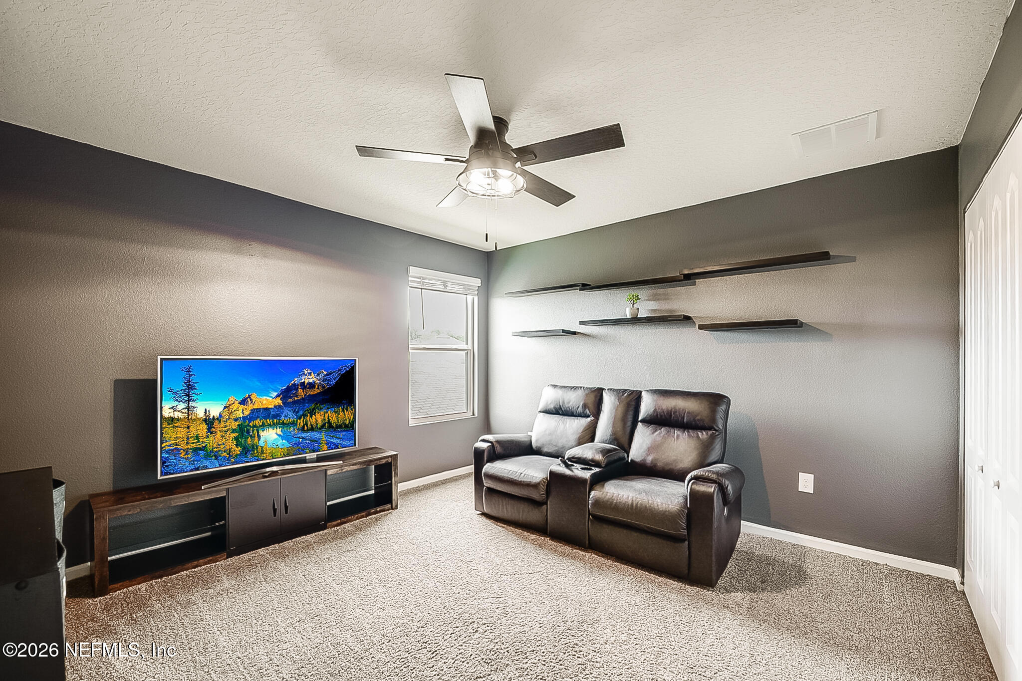 266 Caminha Road St. Augustine, FL 32084 - Photo 28 of 57 a living room with furniture and a flat screen tv