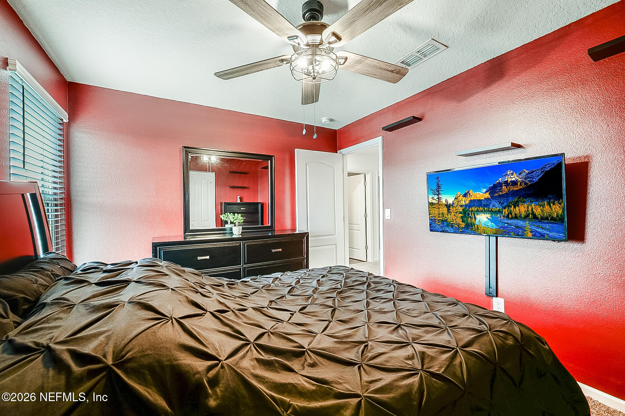 266 Caminha Road St. Augustine, FL 32084 - Photo 31 of 57 a bedroom with a bed and a chandelier