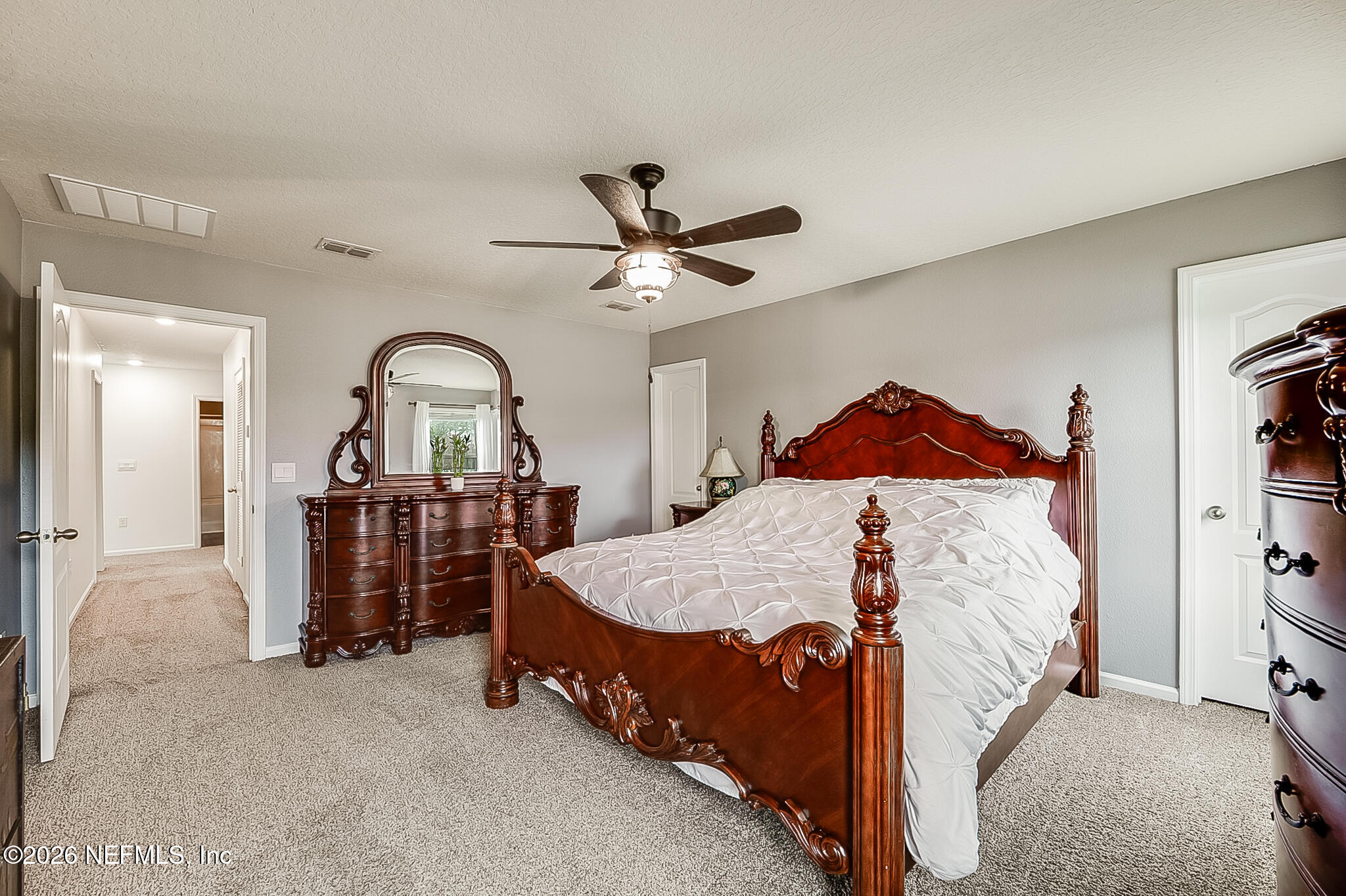 266 Caminha Road St. Augustine, FL 32084 - Photo 33 of 57 a bed room with a bed and a chandelier