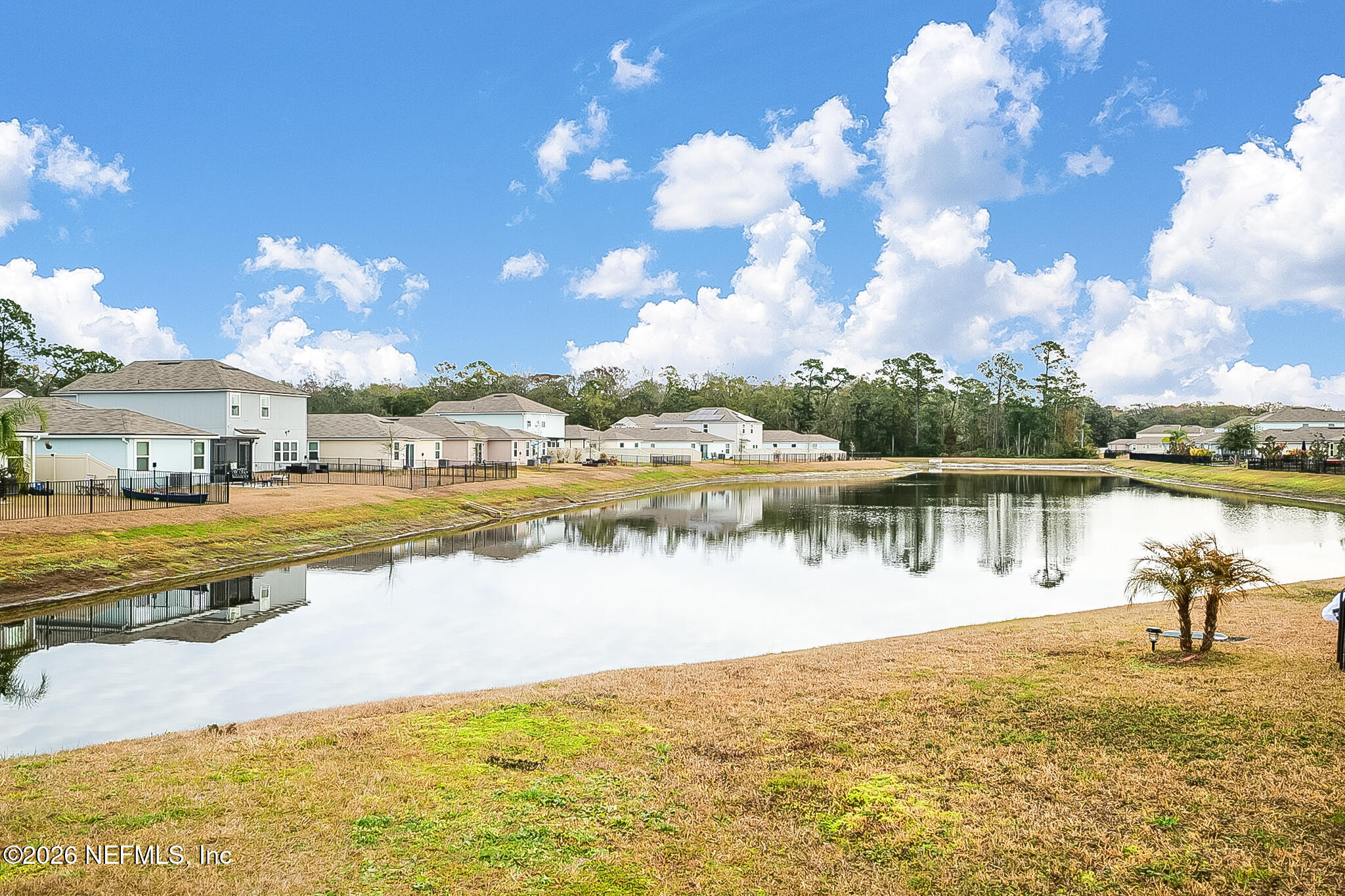 266 Caminha Road St. Augustine, FL 32084 - Photo 42 of 57 a view of a lake with a house in the background