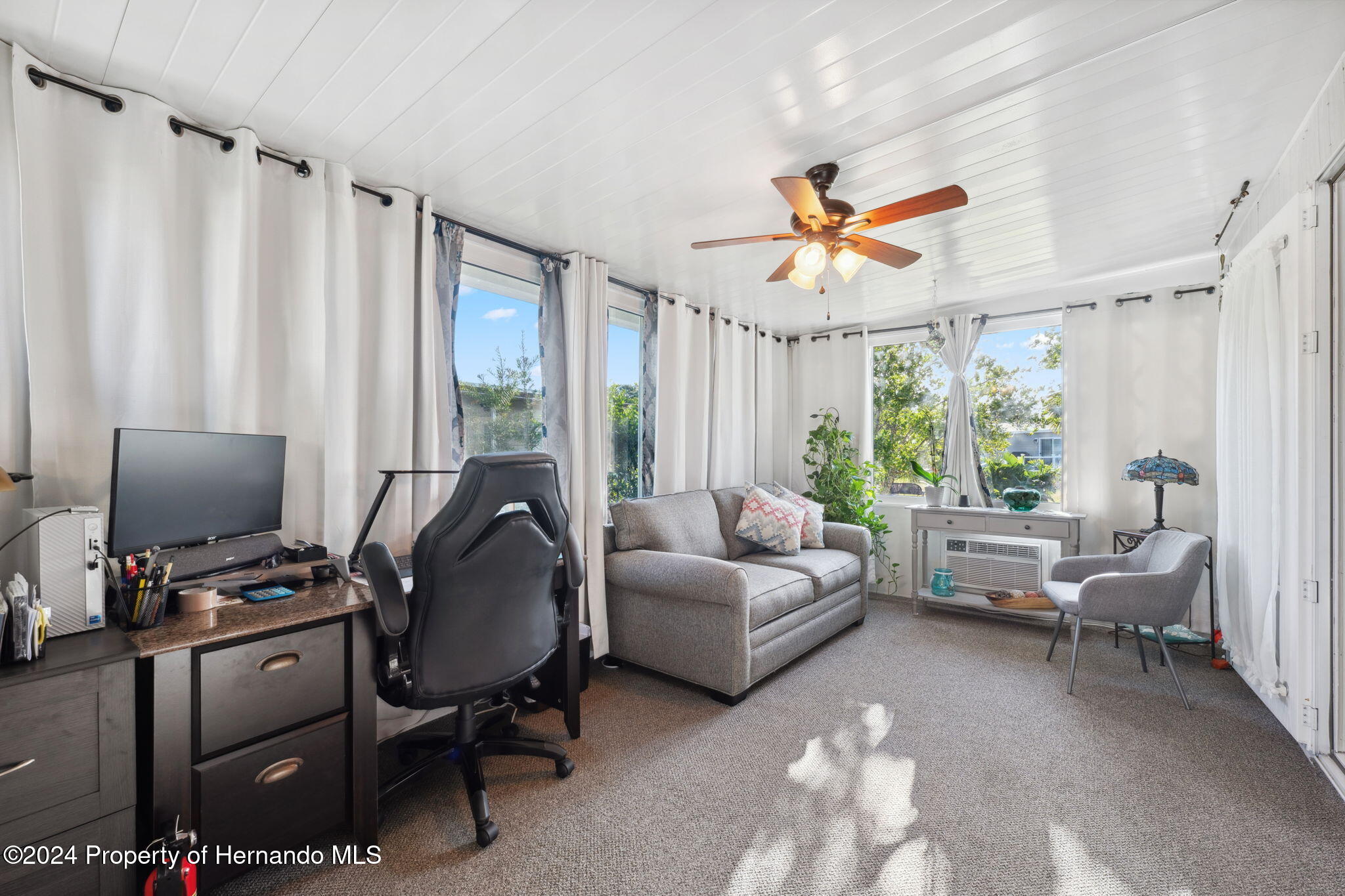 15116 Rialto Avenue Brooksville, FL 34613 - Photo 11 of 36 a living room with furniture ceiling fan and a window