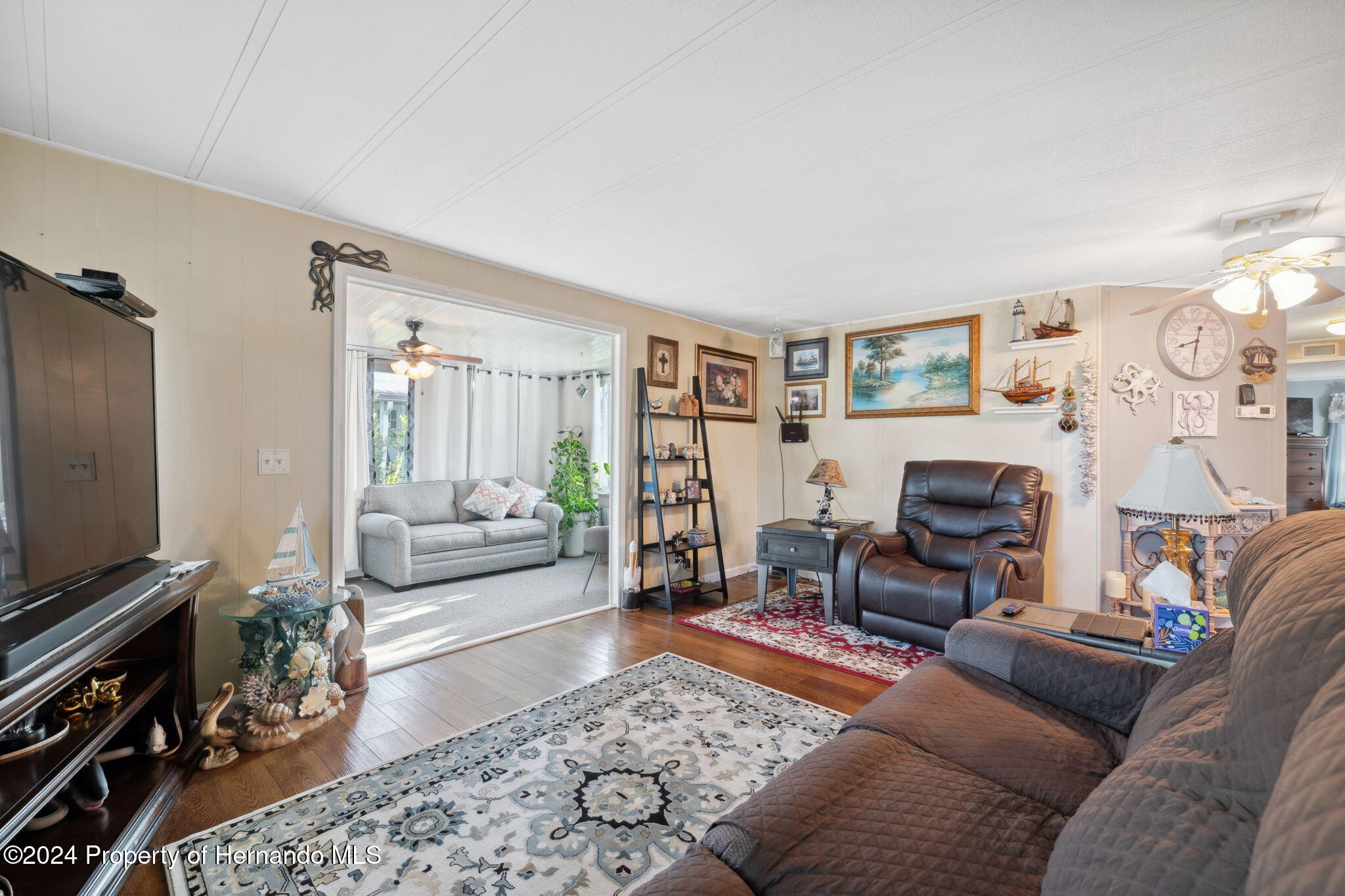 15116 Rialto Avenue Brooksville, FL 34613 - Photo 13 of 36 a living room with furniture and a flat screen tv