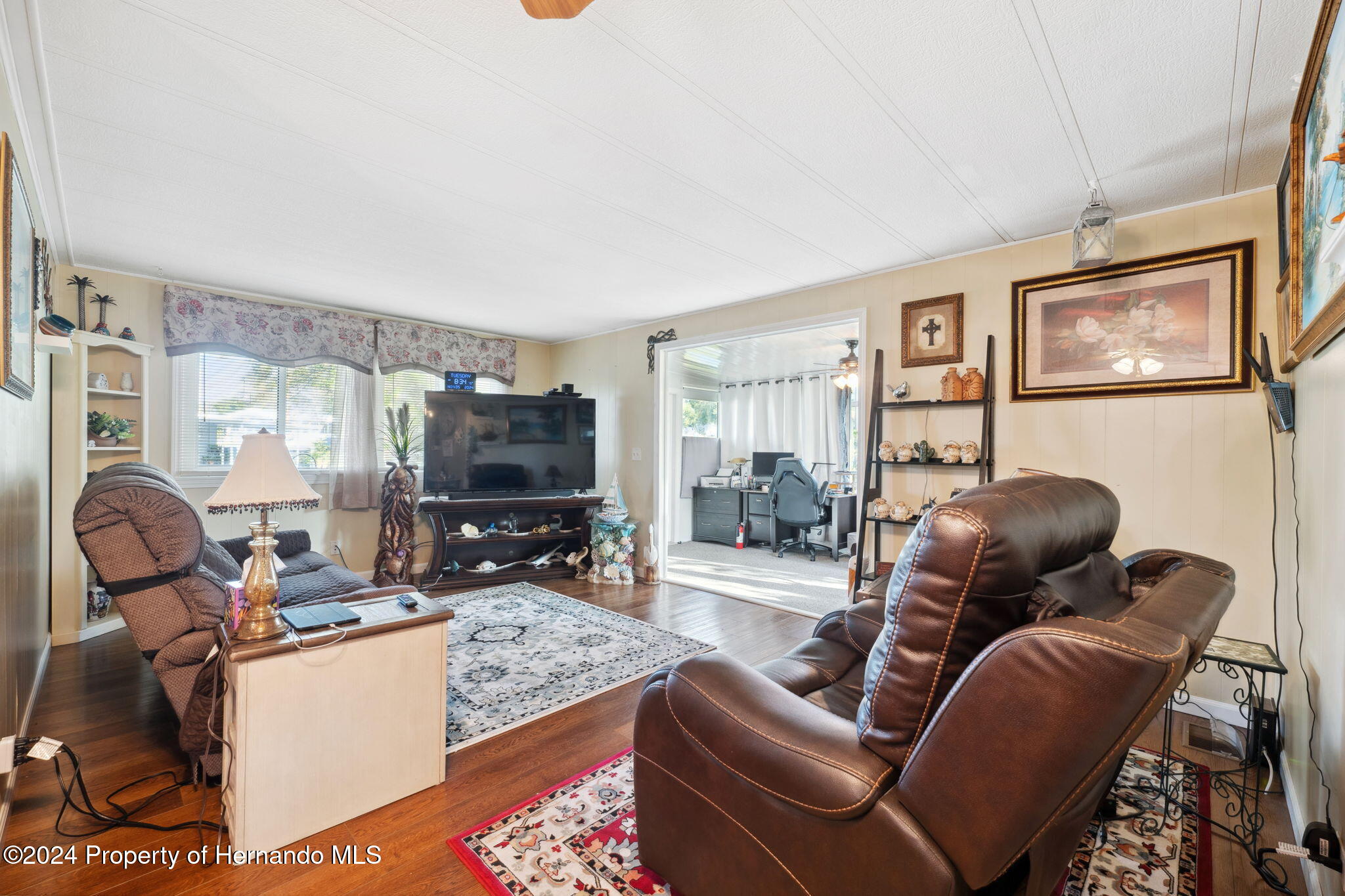 15116 Rialto Avenue Brooksville, FL 34613 - Photo 14 of 36 a living room with furniture and a flat screen tv