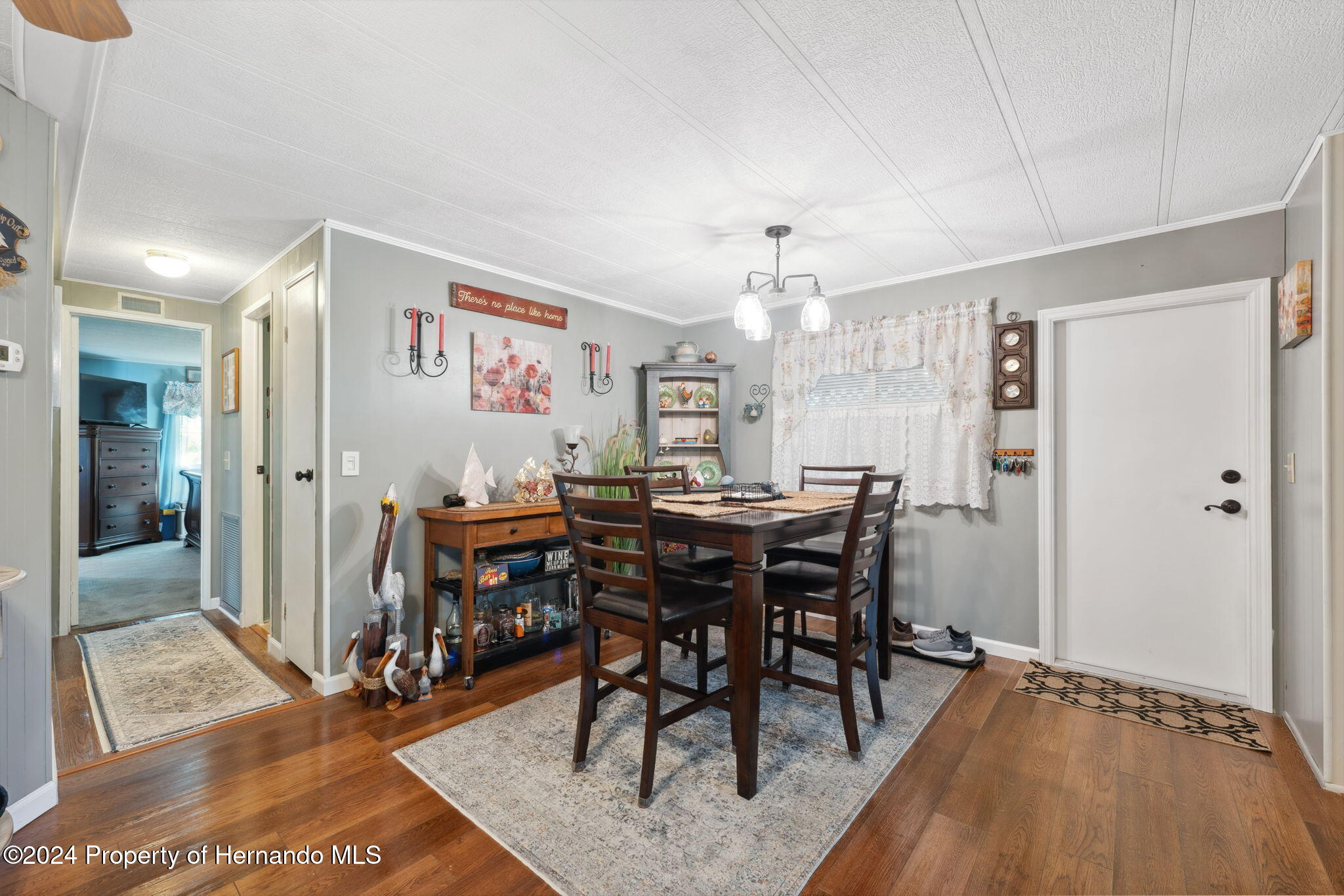 15116 Rialto Avenue Brooksville, FL 34613 - Photo 15 of 36 a view of a dining room with furniture and wooden floor