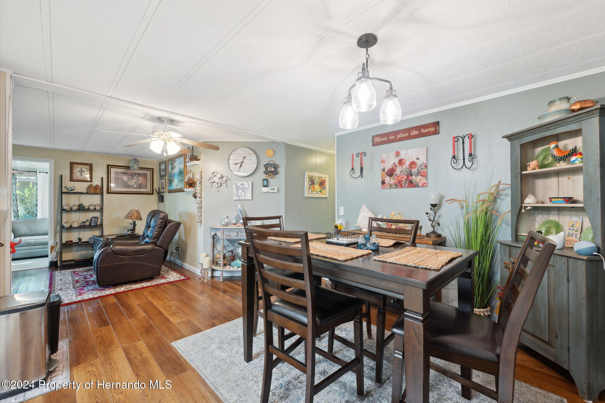 15116 Rialto Avenue Brooksville, FL 34613 - Photo 17 of 36 a view of a dining room with furniture and wooden floor