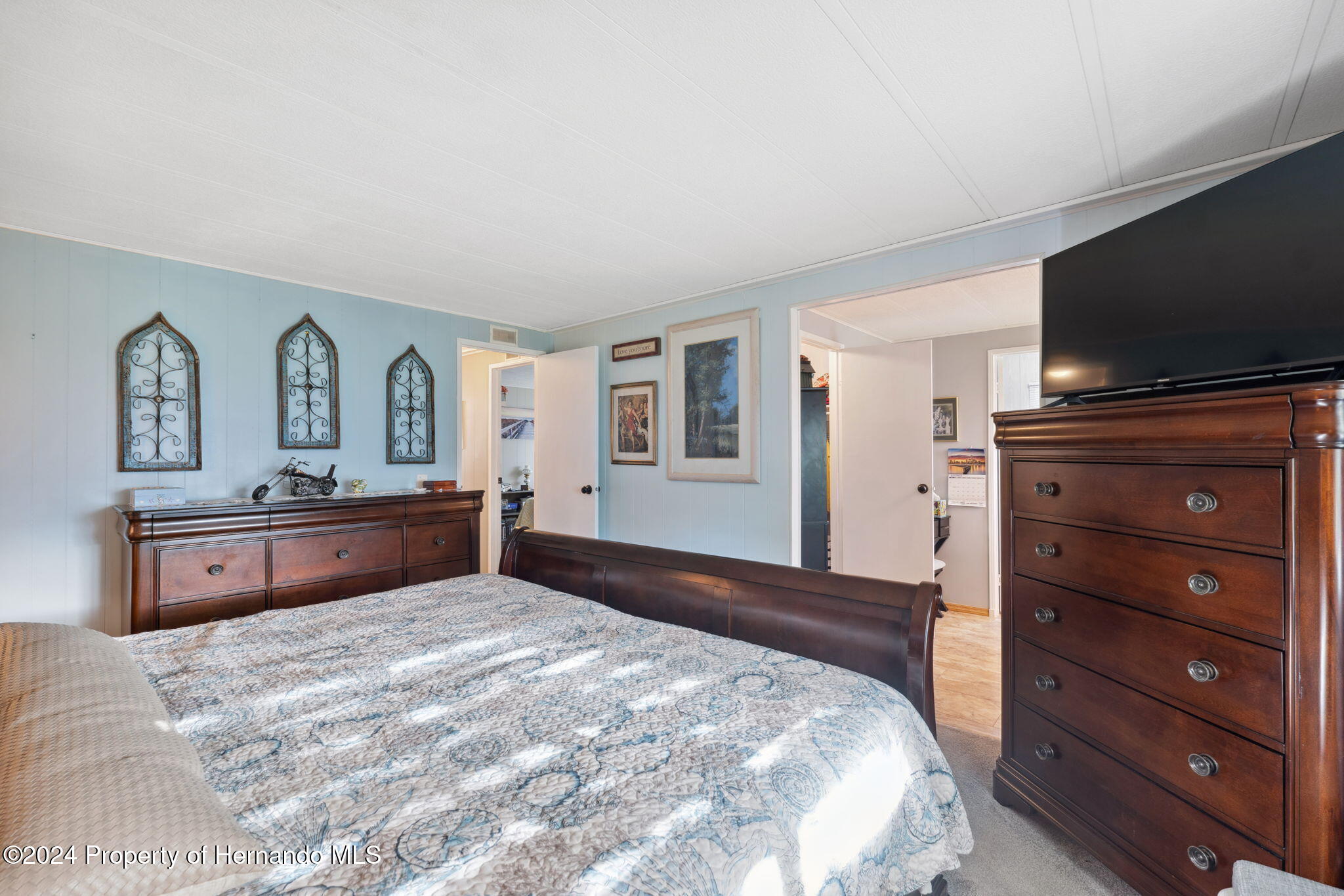 15116 Rialto Avenue Brooksville, FL 34613 - Photo 23 of 36 a bedroom with a bed and a flat screen tv