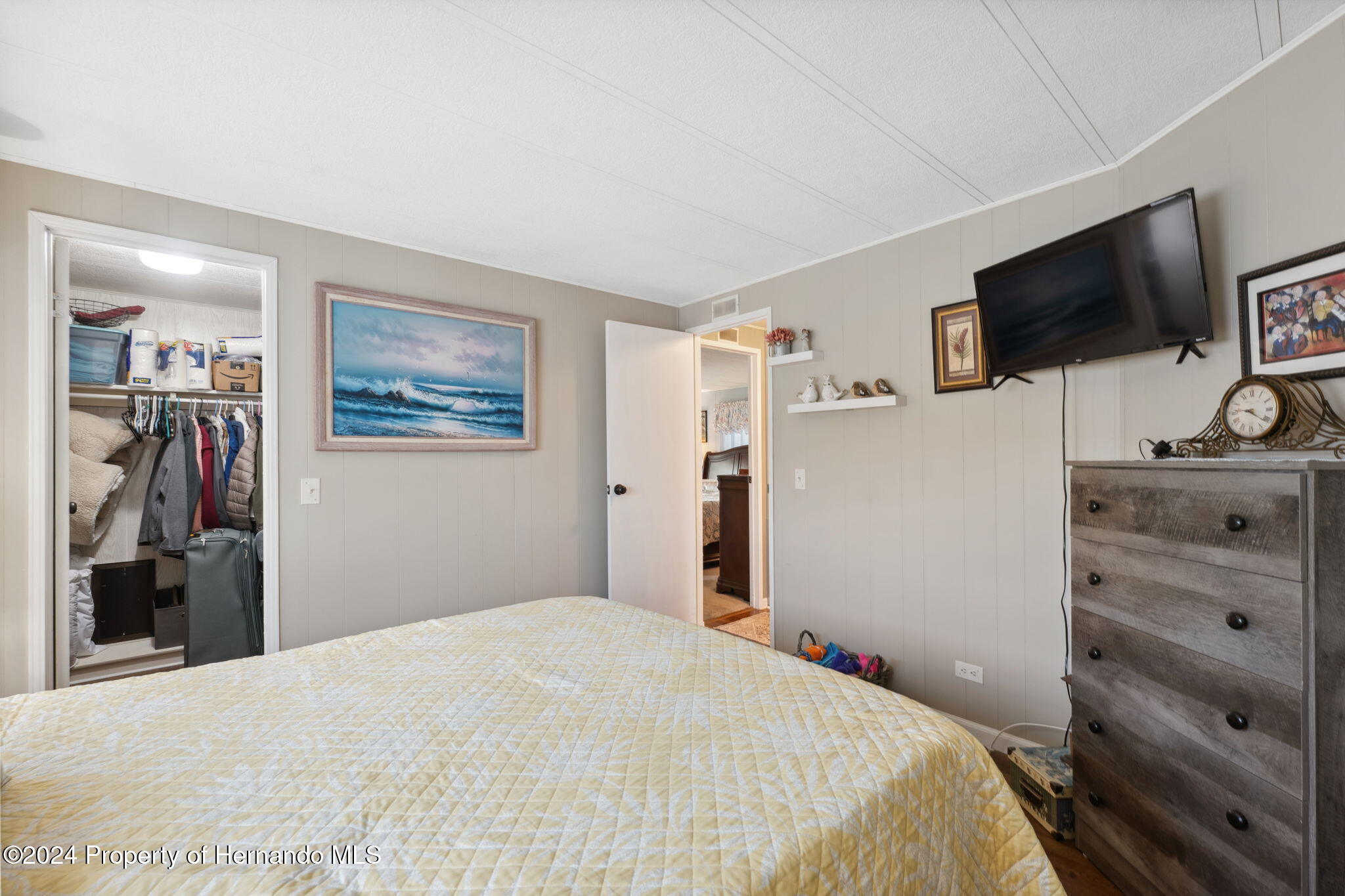 15116 Rialto Avenue Brooksville, FL 34613 - Photo 30 of 36 a bedroom with a bed and a flat screen tv