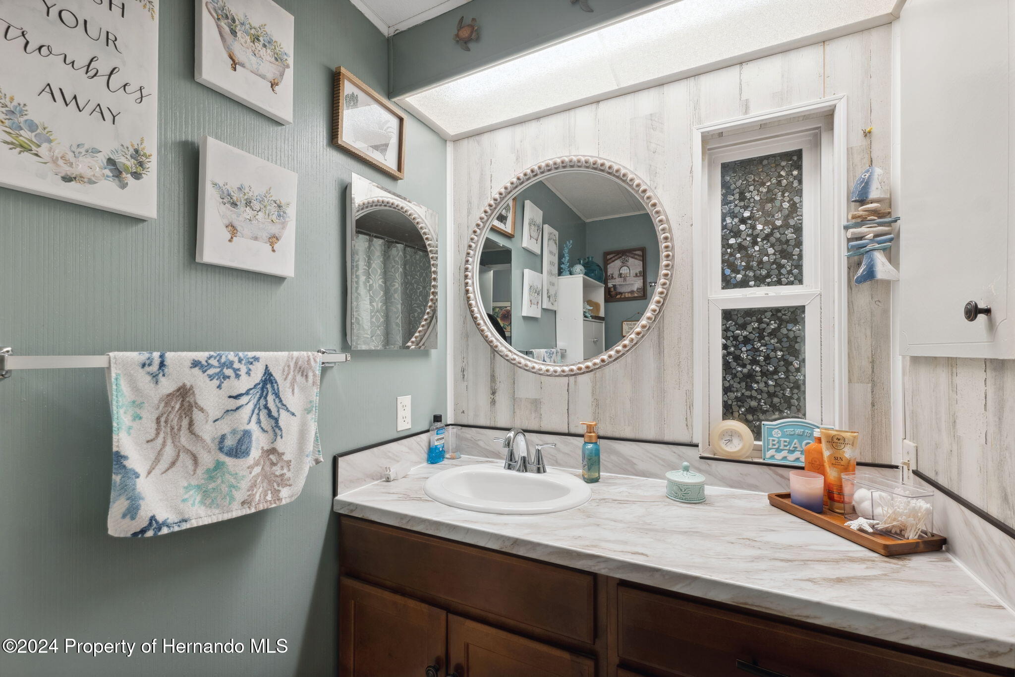 15116 Rialto Avenue Brooksville, FL 34613 - Photo 32 of 36 a bathroom with a granite countertop double vanity sink and a mirror